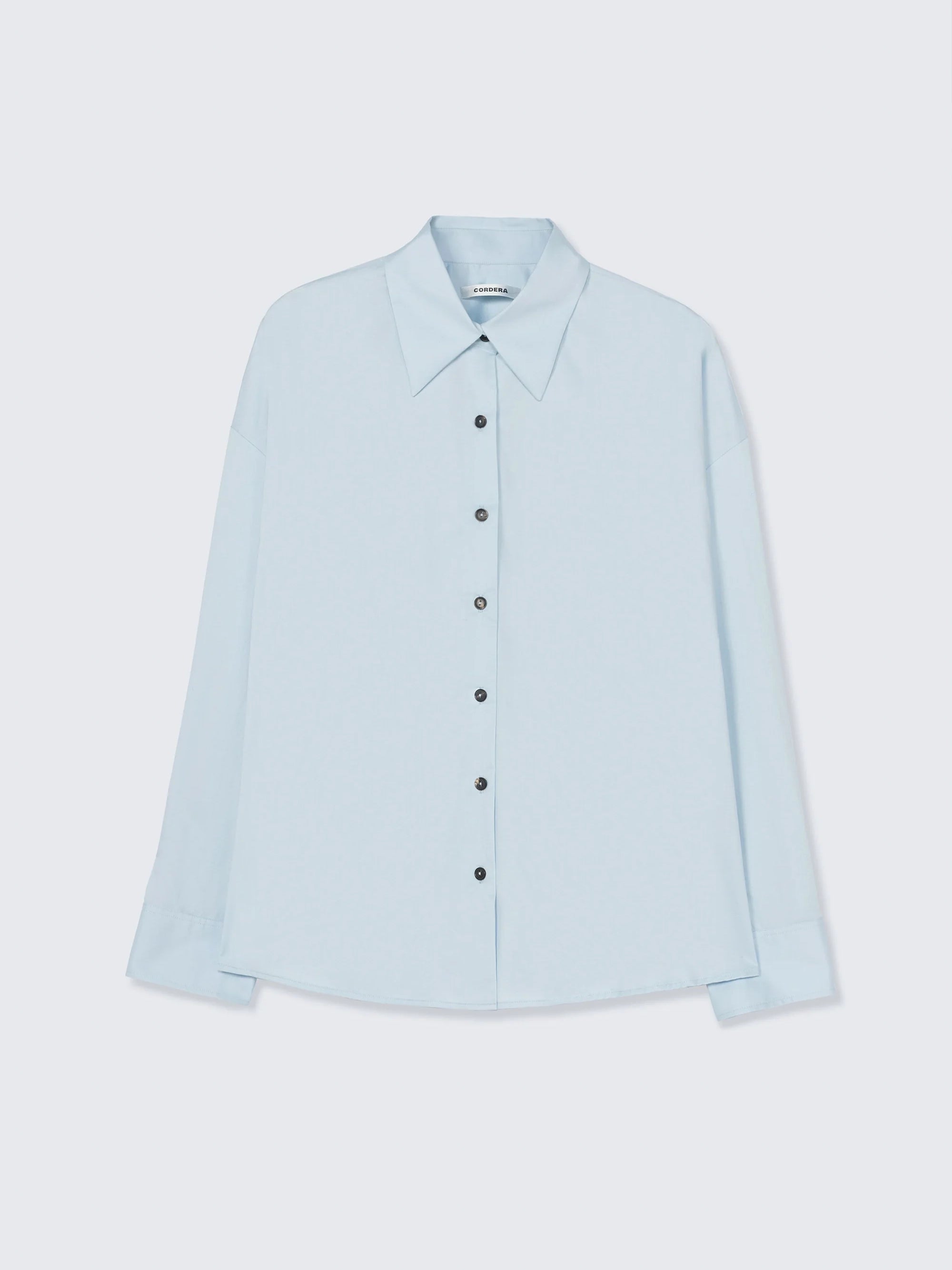 Light blue shirt on a light gray background