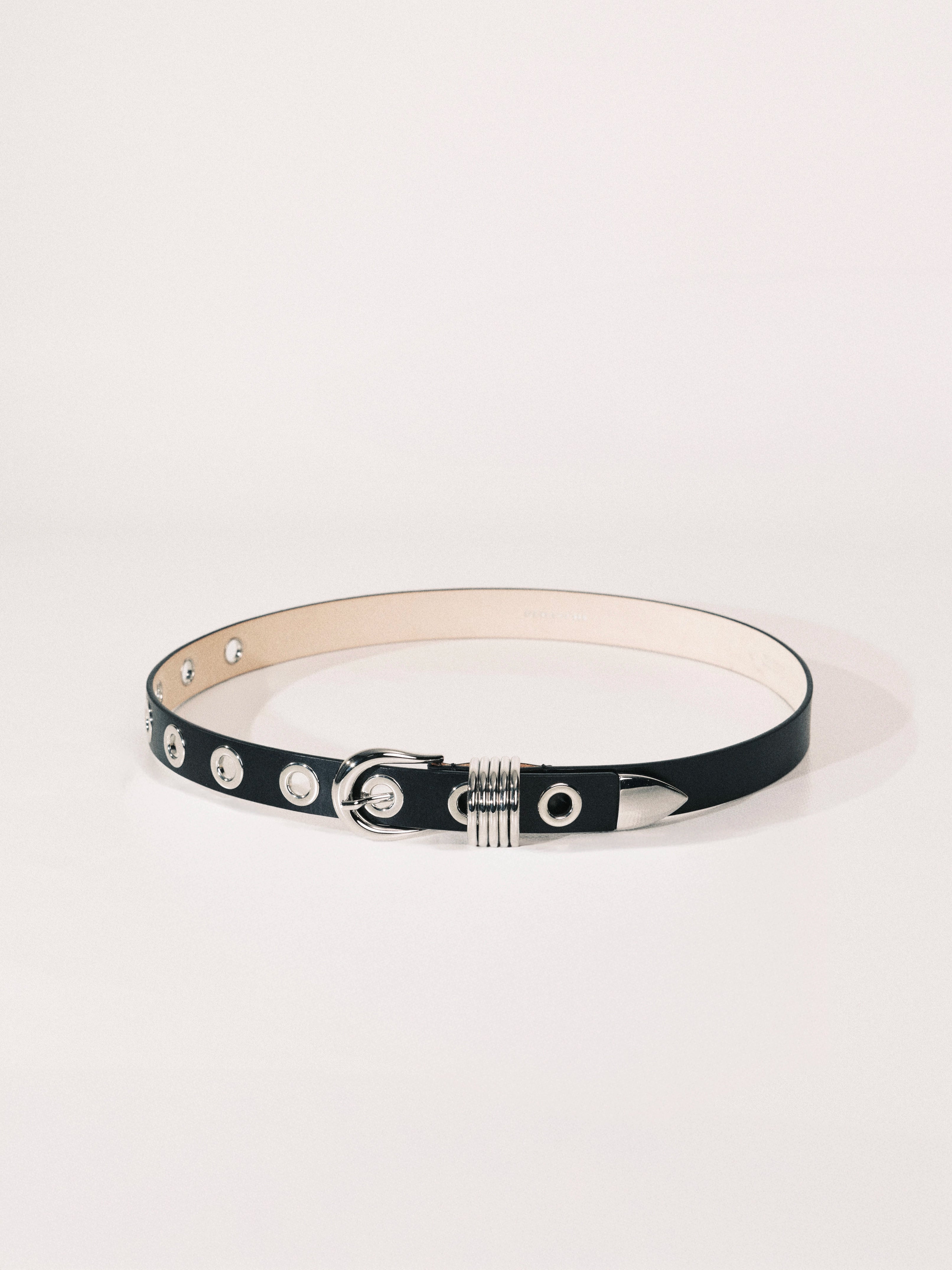 Black leather belt with silver hardware on a white background