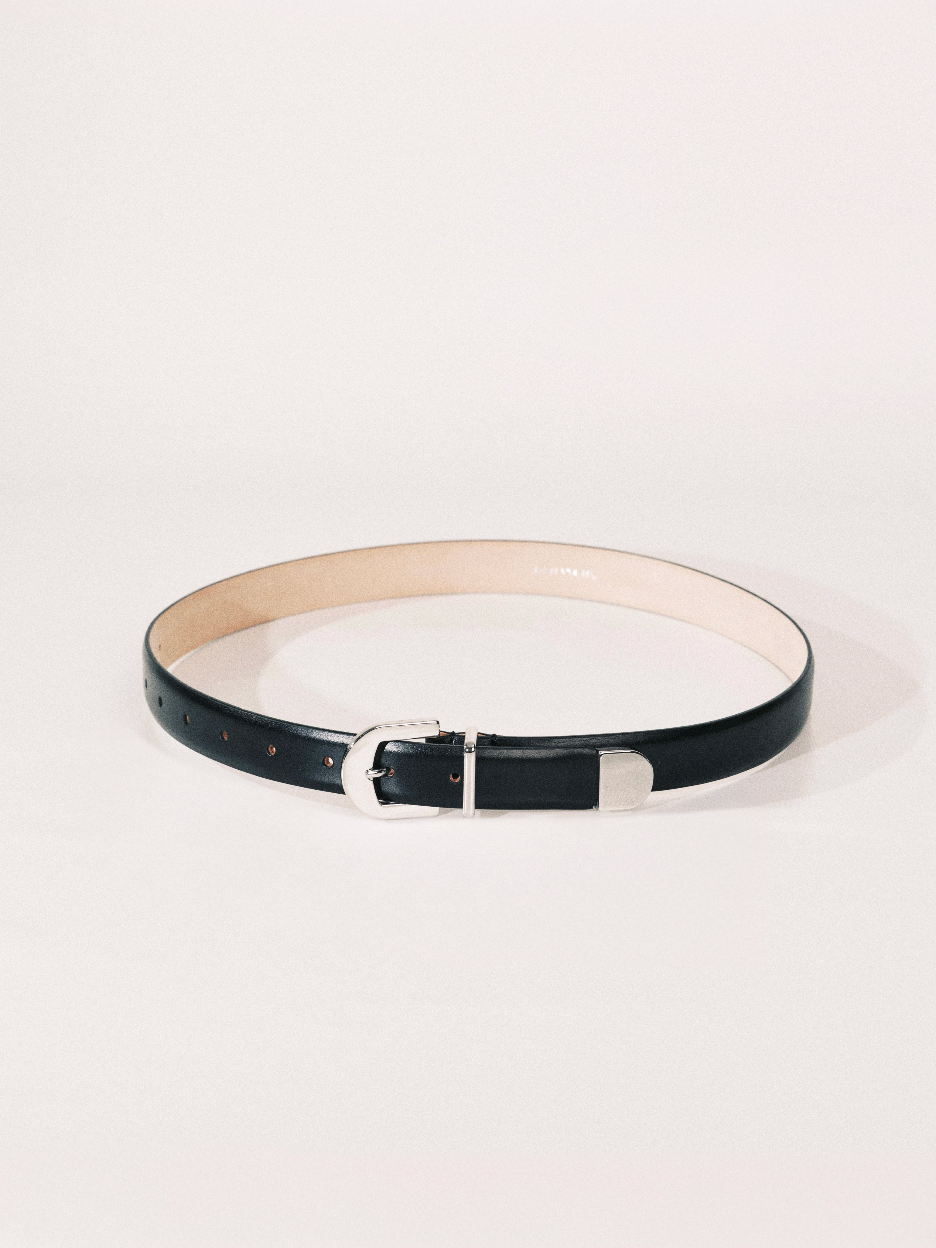 Black belt with a silver buckle on a white background