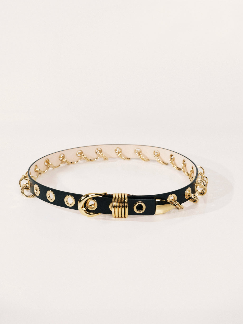 Black choker with gold accents on a white background