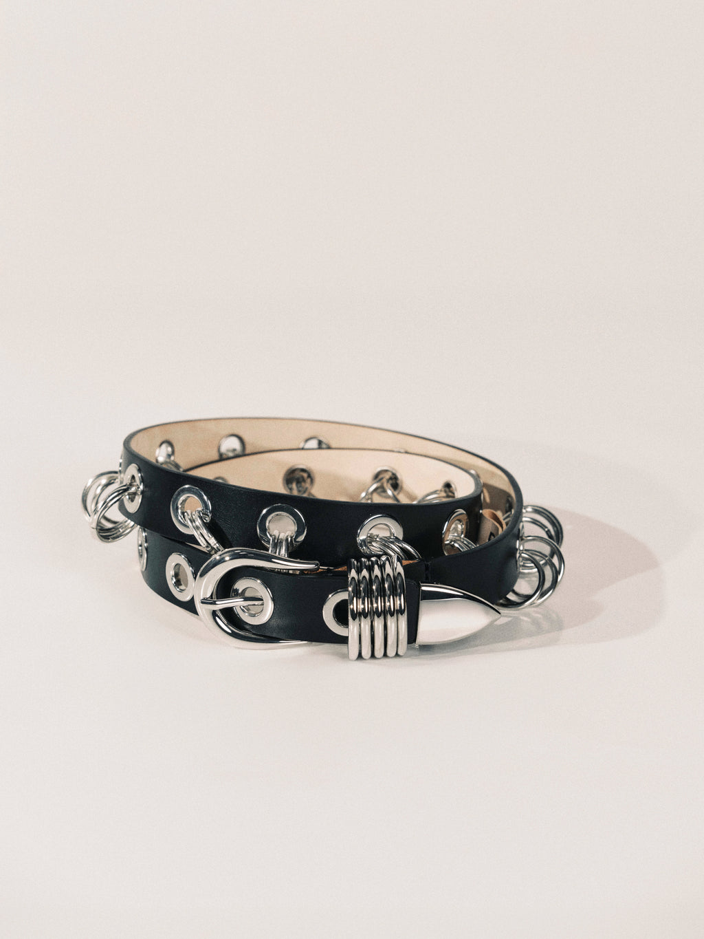 Black leather bracelet with silver metal accents on a white background