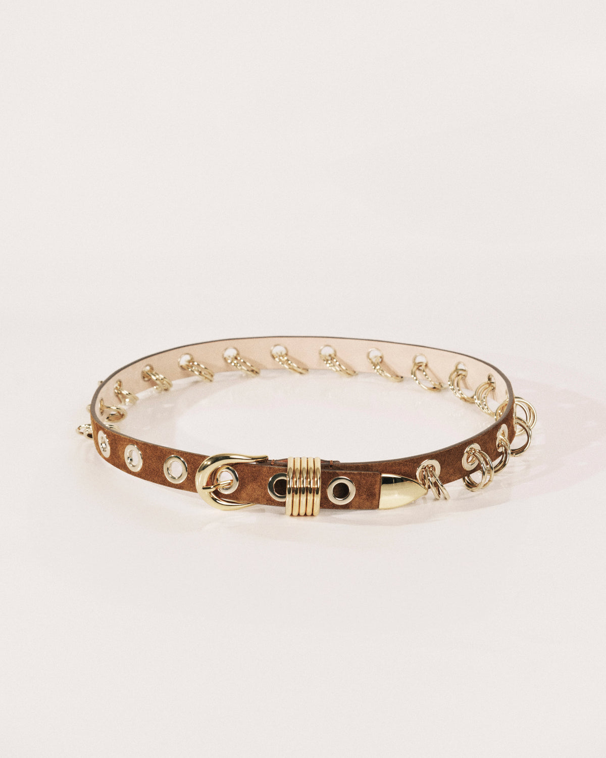 Brown suede belt with polished gold buckle, ring detailing and wrapped metal keeper by Déhanche.