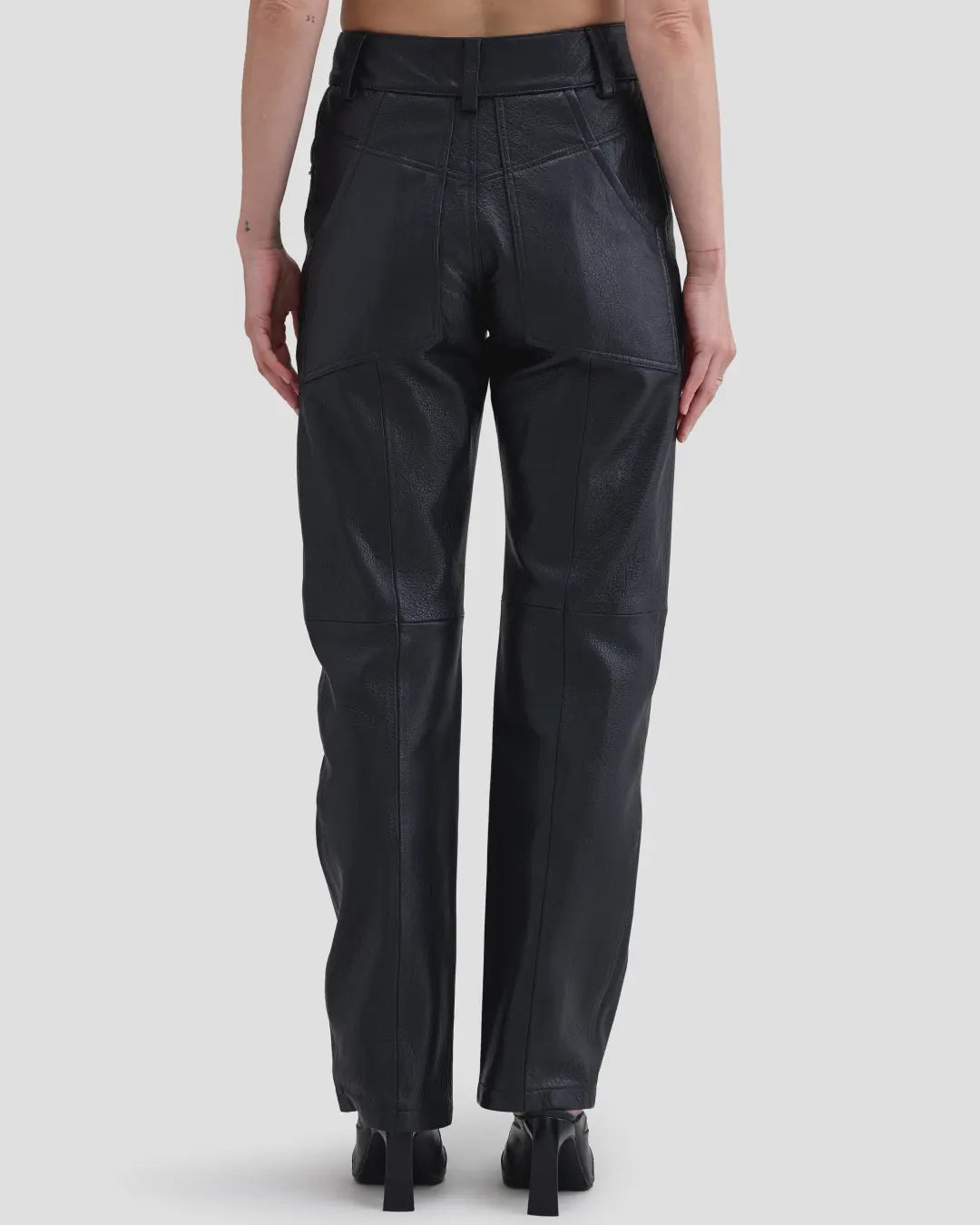 Back view of model wearing Eckhaus Latta Cruising Jean in Dusk with a high-rise straight leg in black leather.