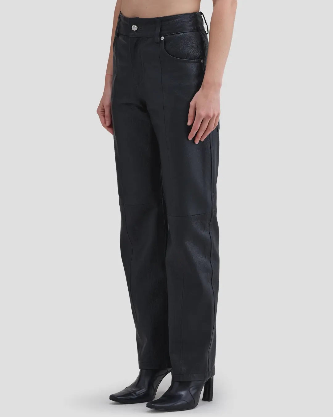 Side view of model wearing Eckhaus Latta Cruising Jean in Dusk with a high-rise straight leg in black leather.