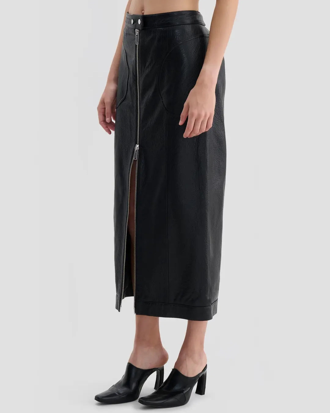 Side view of Eckhaus Latta Cruising Skirt in dusk with a high-rise, straight silhouette and center-front zip closure.
