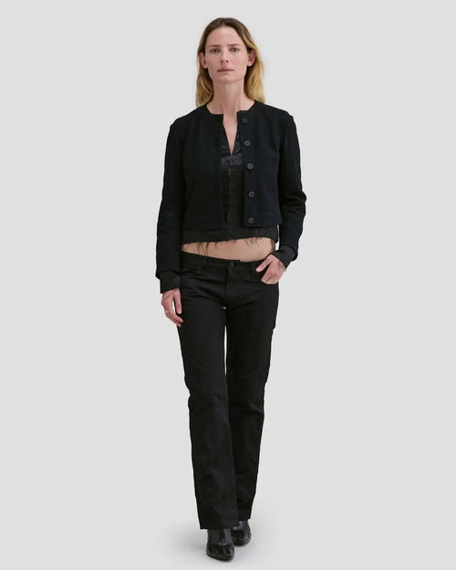 Model wearing Eckhaus Latta Double Jacket in coal with a cropped, structured shape and layered construction.