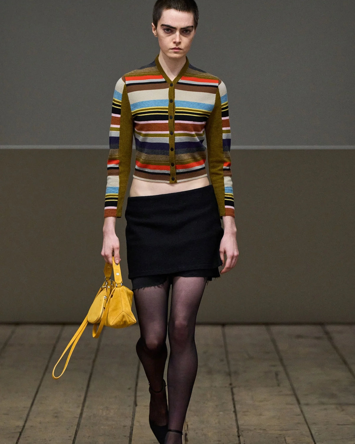 Model wearing Eckhaus Latta Double Skirt in black with a layered mini silhouette and raw underlayer hem.