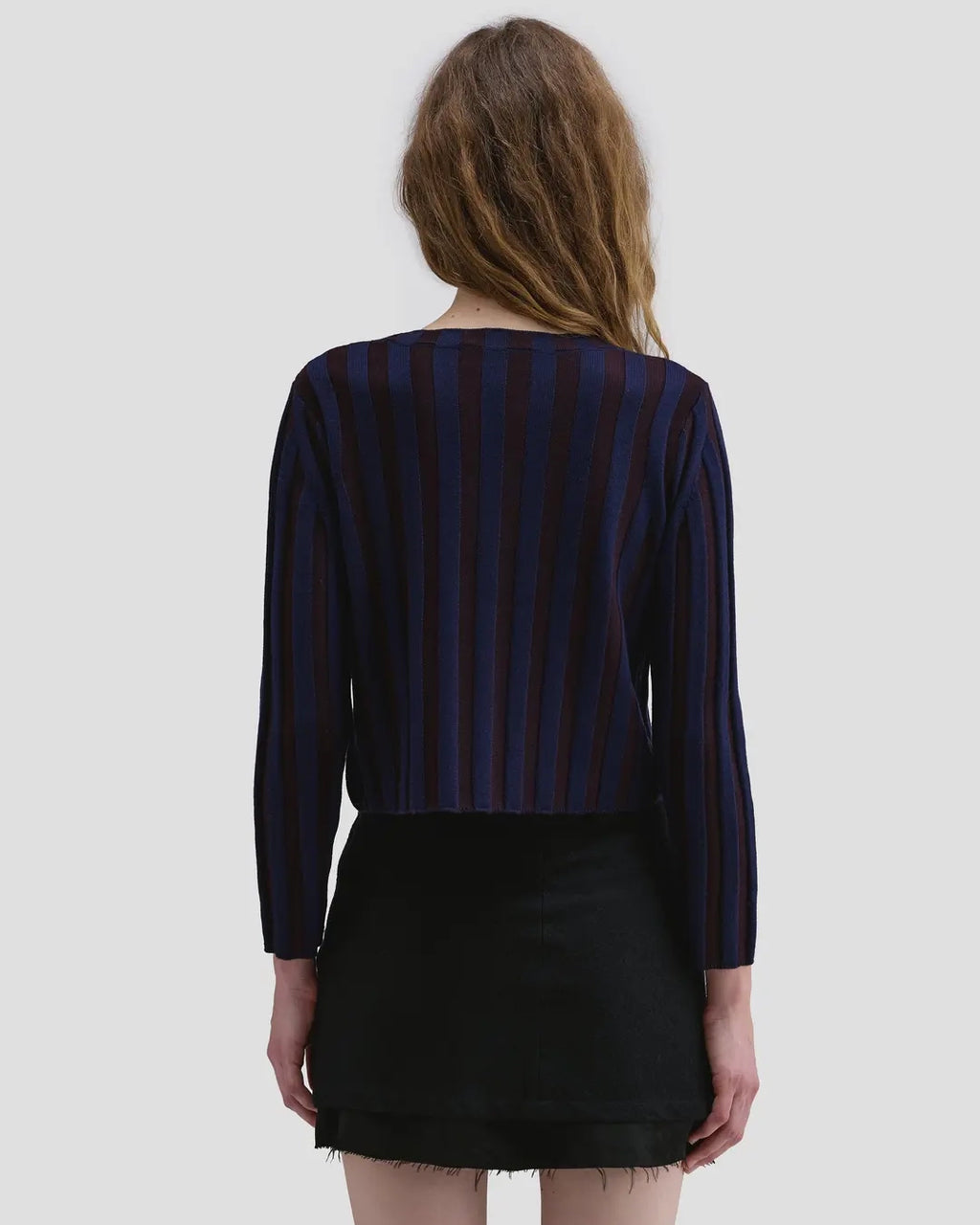 Back view of model wearing the Eckhaus Latta Keyboard Zip Cardigan in port with a fitted shape, contrast stripes and front zip.