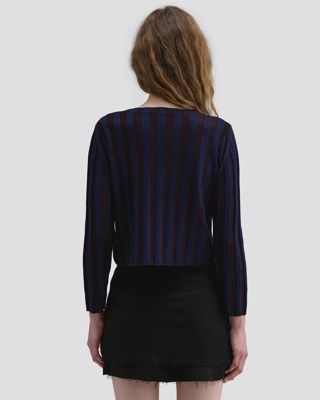 Back view of model wearing the Eckhaus Latta Keyboard Zip Cardigan in port with a fitted shape, contrast stripes and front zip.