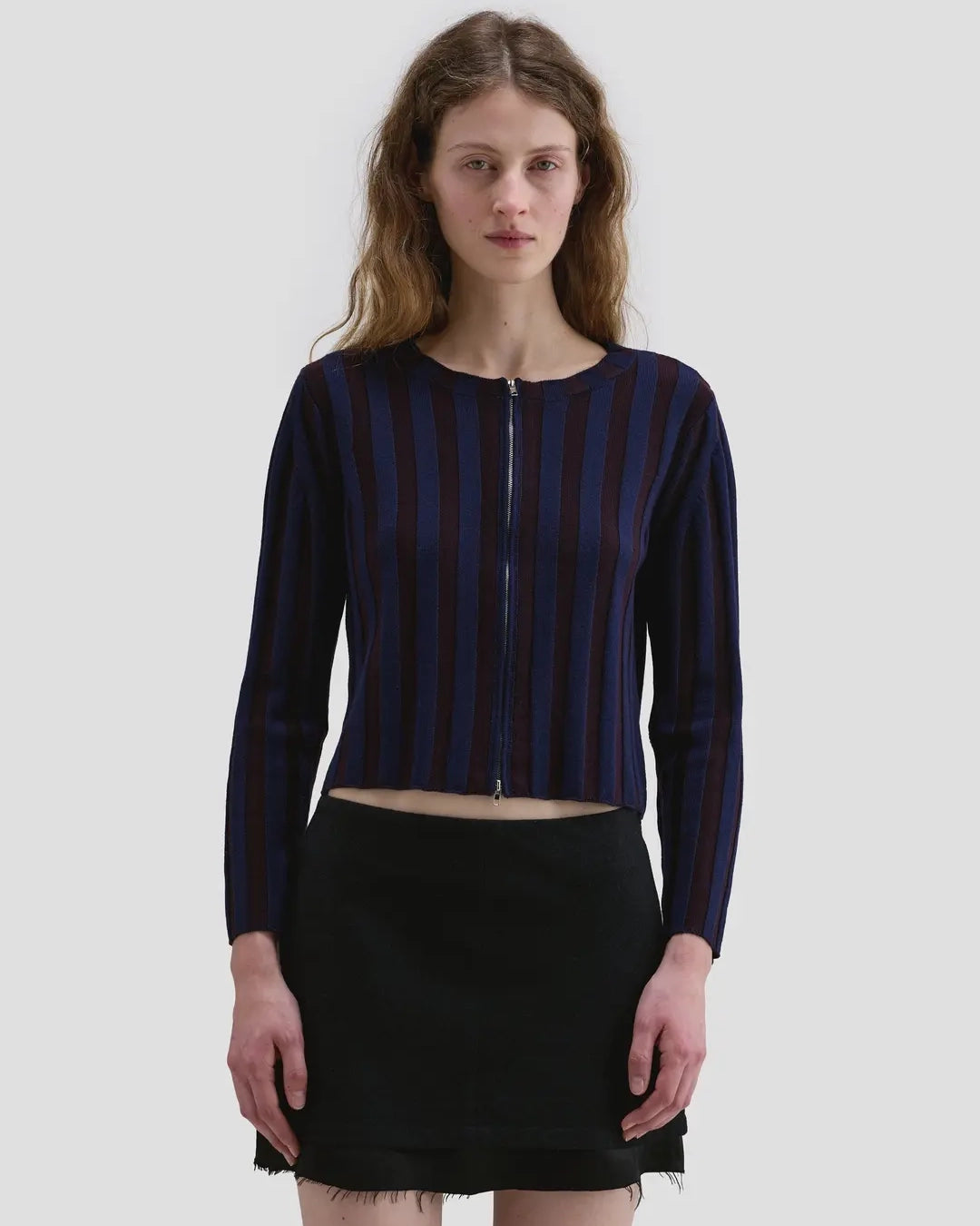 Model wearing the Eckhaus Latta Keyboard Zip Cardigan in port with a fitted shape, contrast stripes and front zip.