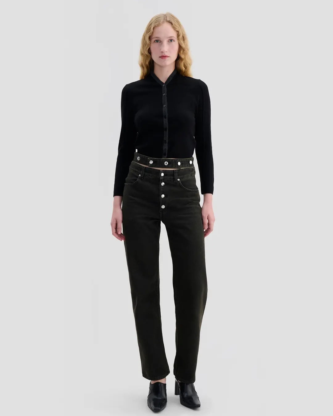Model wearing Eckhaus Latta Racer Cardigan in black with charcoal trim and a shrunken fit.
