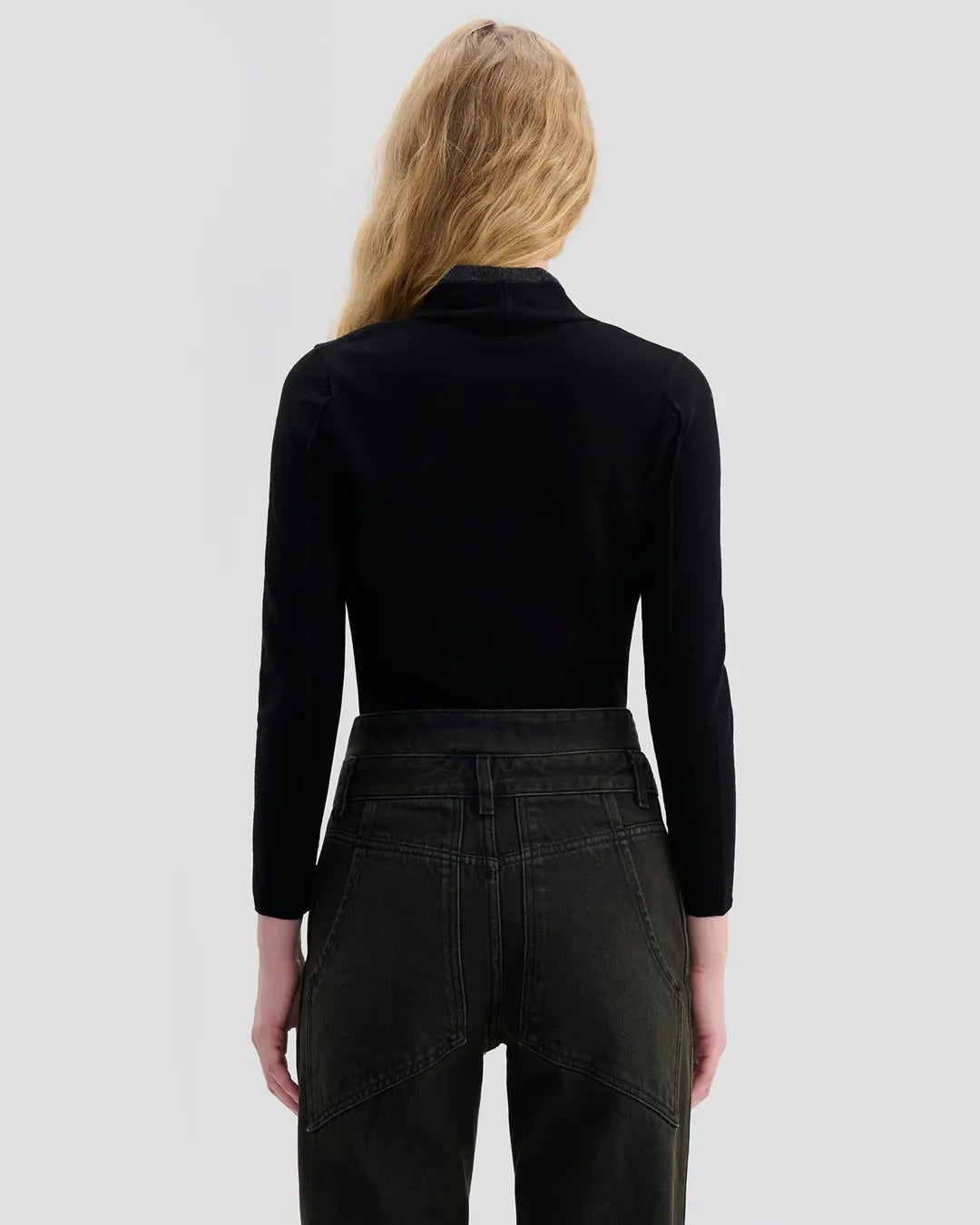 Back view of model wearing Eckhaus Latta Racer Cardigan in black with charcoal trim and a shrunken fit.