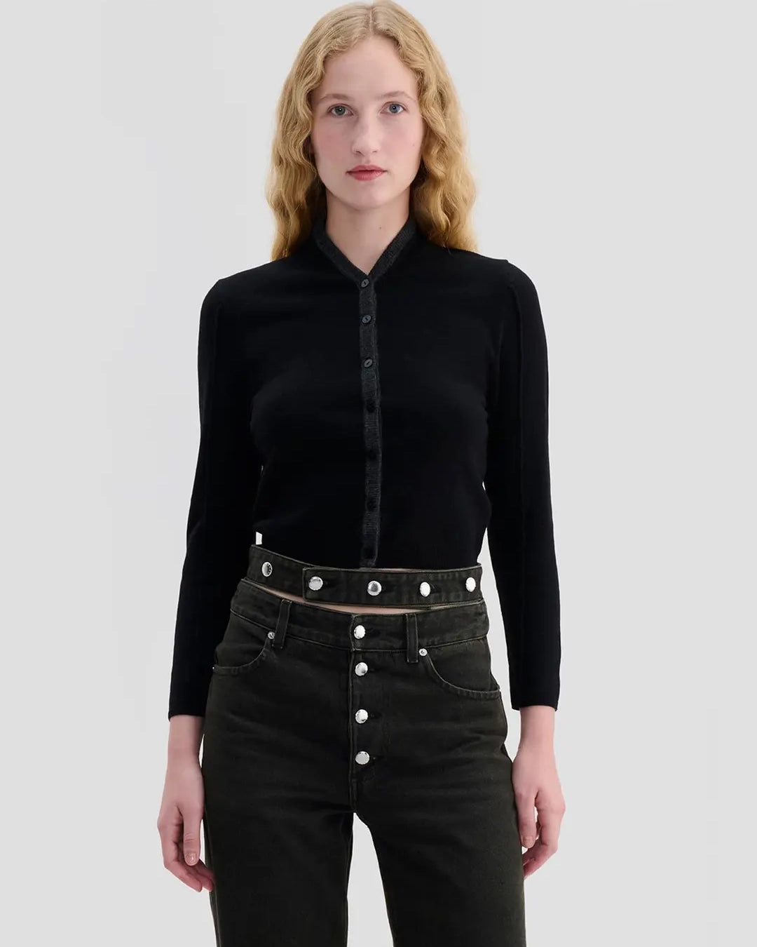 Model wearing Eckhaus Latta Racer Cardigan in black with charcoal trim and a shrunken fit.