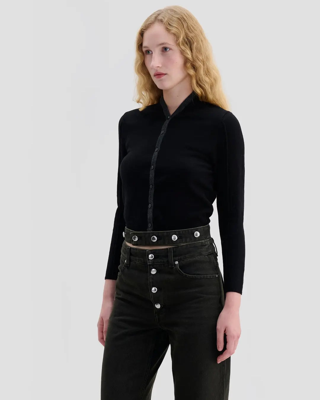 Side view of model wearing Eckhaus Latta Racer Cardigan in black with charcoal trim and a shrunken fit.