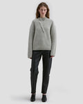 Model wearing Eckhaus Latta Roving Pullover in dove with a relaxed fit and asymmetrical Henley collar.