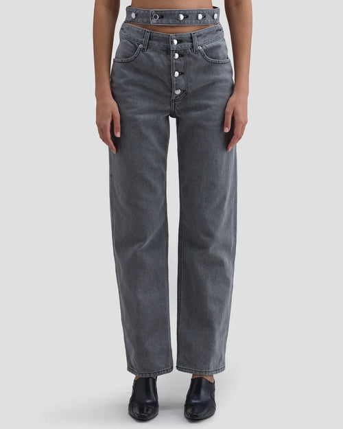 Detail view of model wearing Eckhaus Latta Shadow Jean in cement with a high-rise, slightly tapered fit and double waistband.