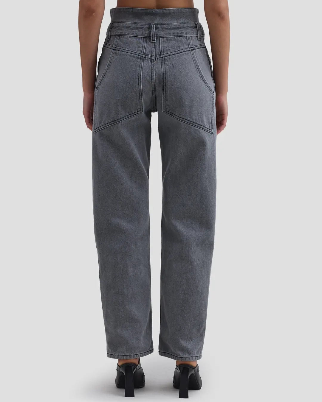 Back view of model wearing Eckhaus Latta Shadow Jean in cement with a high-rise, slightly tapered fit and double waistband.