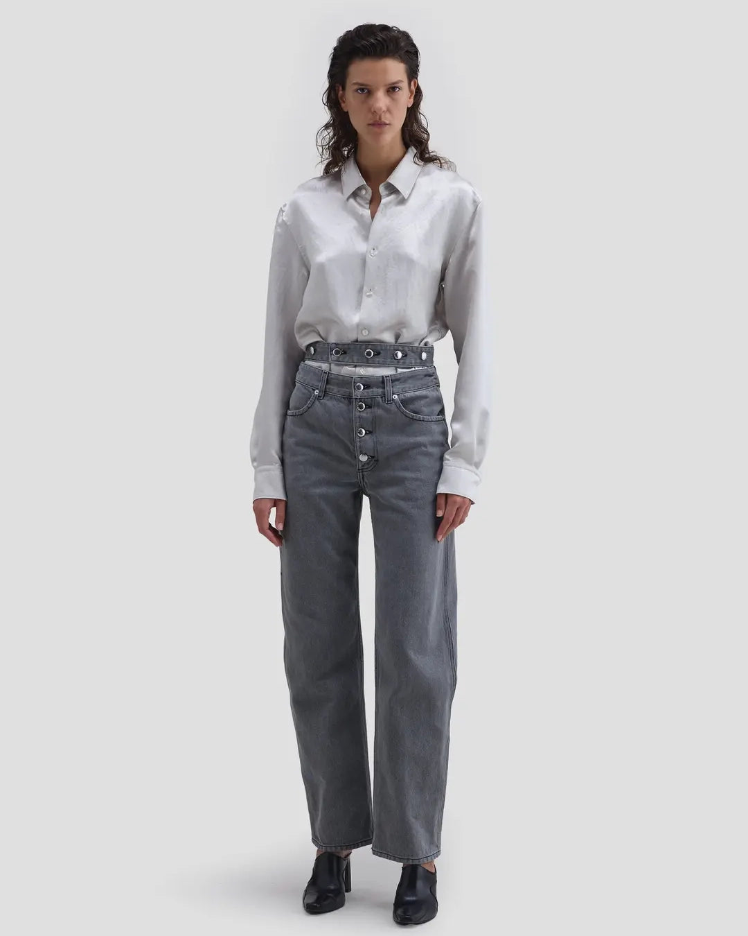 Model wearing Eckhaus Latta Shadow Jean in cement with a high-rise, slightly tapered fit and double waistband.