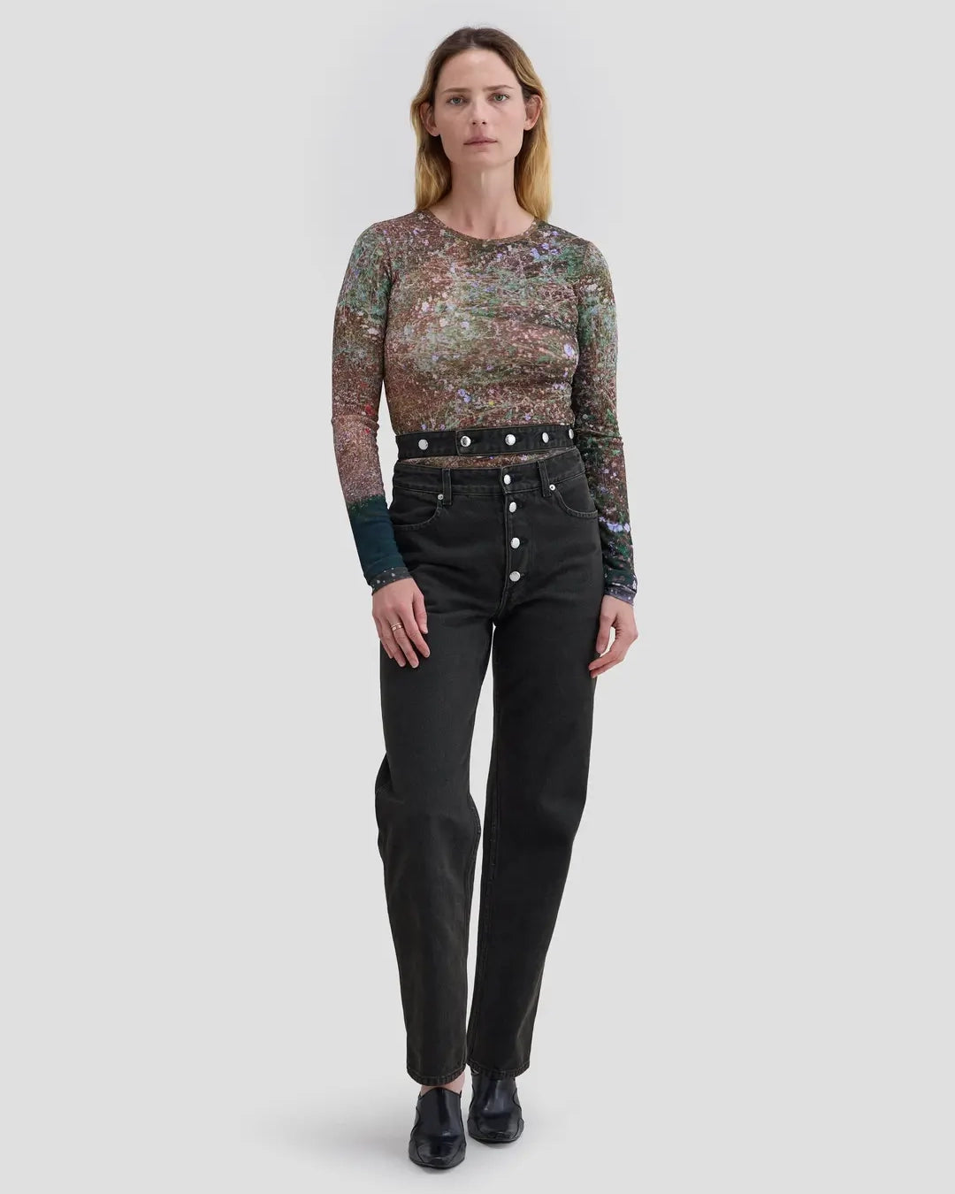 Model wearing Eckhaus Latta Shadow Jean in soot with a high-rise, slightly tapered fit and double waistband.