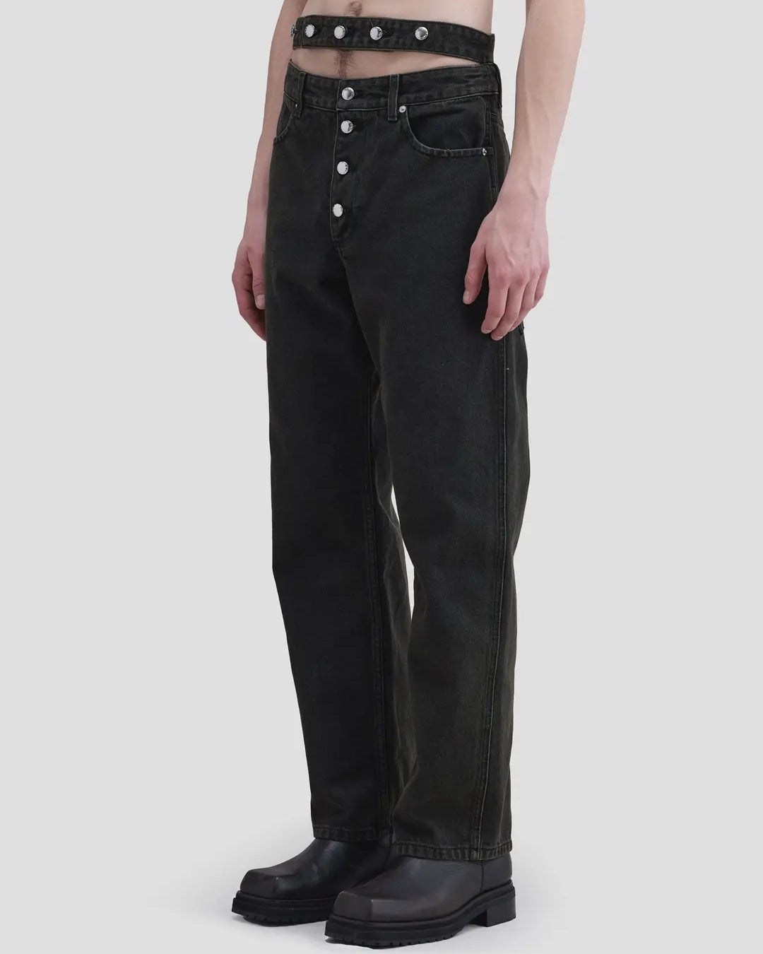 Detail view of model wearing Eckhaus Latta Shadow Jean in soot with a high-rise, slightly tapered fit and double waistband.