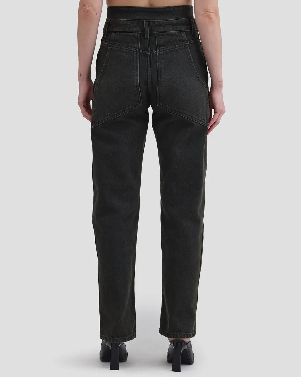 Back detail view of model wearing Eckhaus Latta Shadow Jean in soot with a high-rise, slightly tapered fit and double waistband.