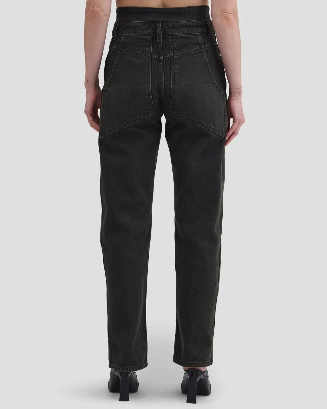 Back detail view of model wearing Eckhaus Latta Shadow Jean in soot with a high-rise, slightly tapered fit and double waistband.
