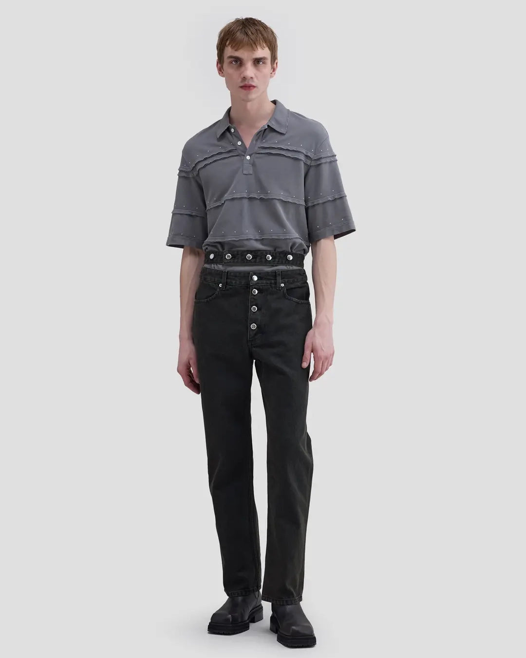 Model wearing Eckhaus Latta Shadow Jean in soot with a high-rise, slightly tapered fit and double waistband.