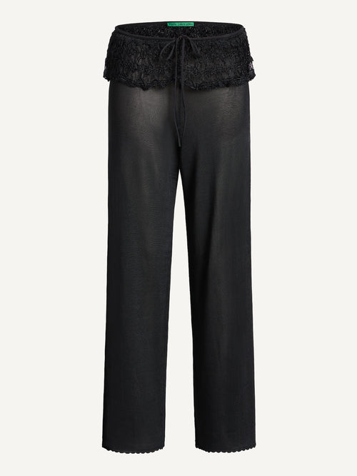 Black pants with lace trim on a white background