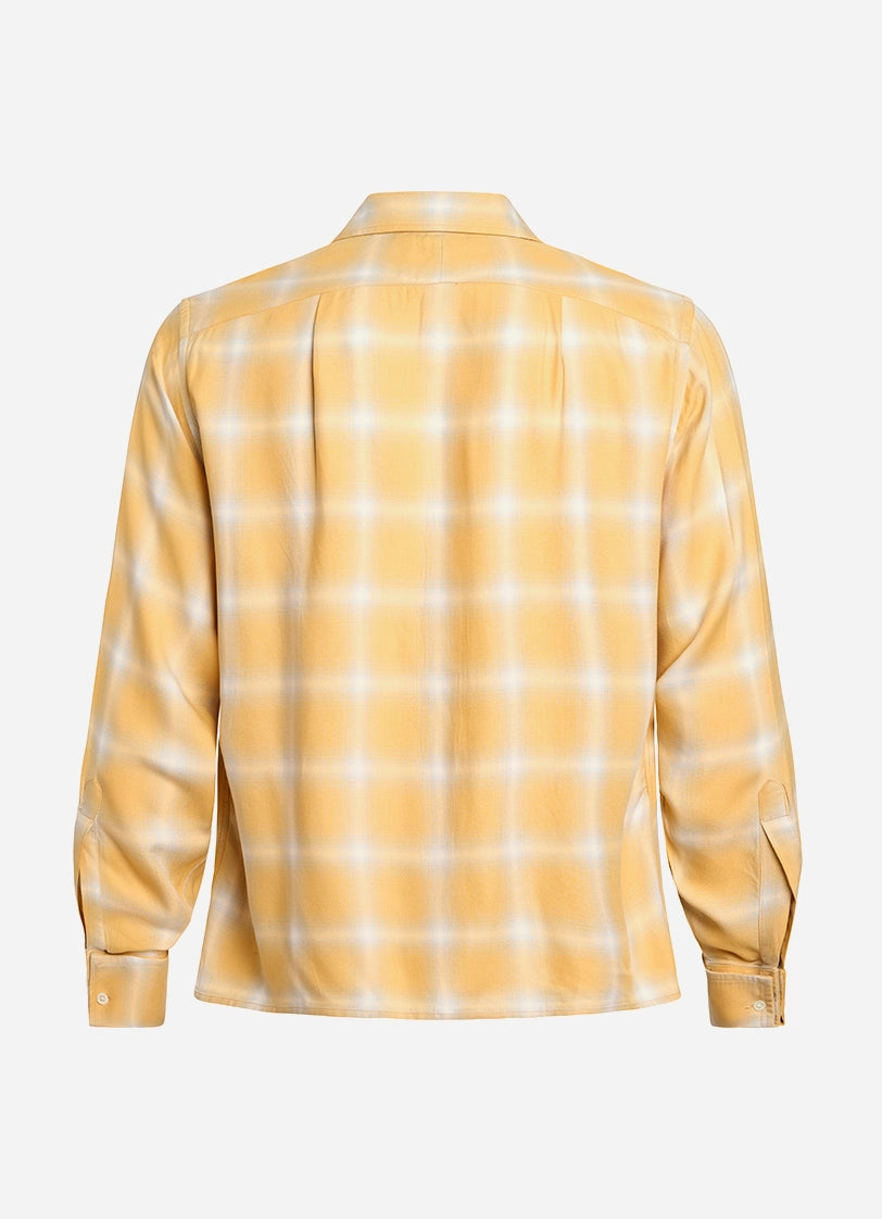 Yellow and white checkered shirt on a light gray background