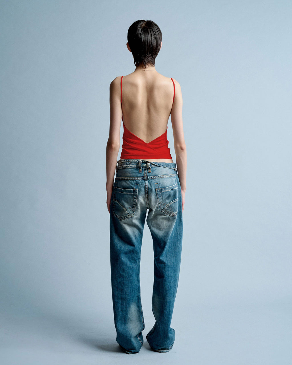 Back view of model wearing Kipling Backless Tank in Rosso Corsa by EMILY DAWN LONG