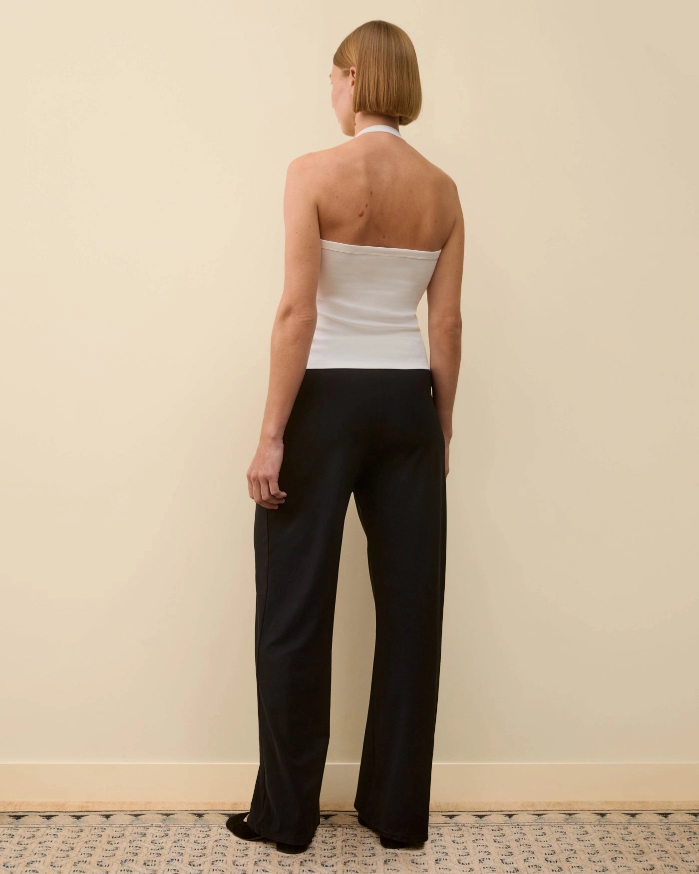 Back view of model wearing Angie Tank in White by FLORE FLORE