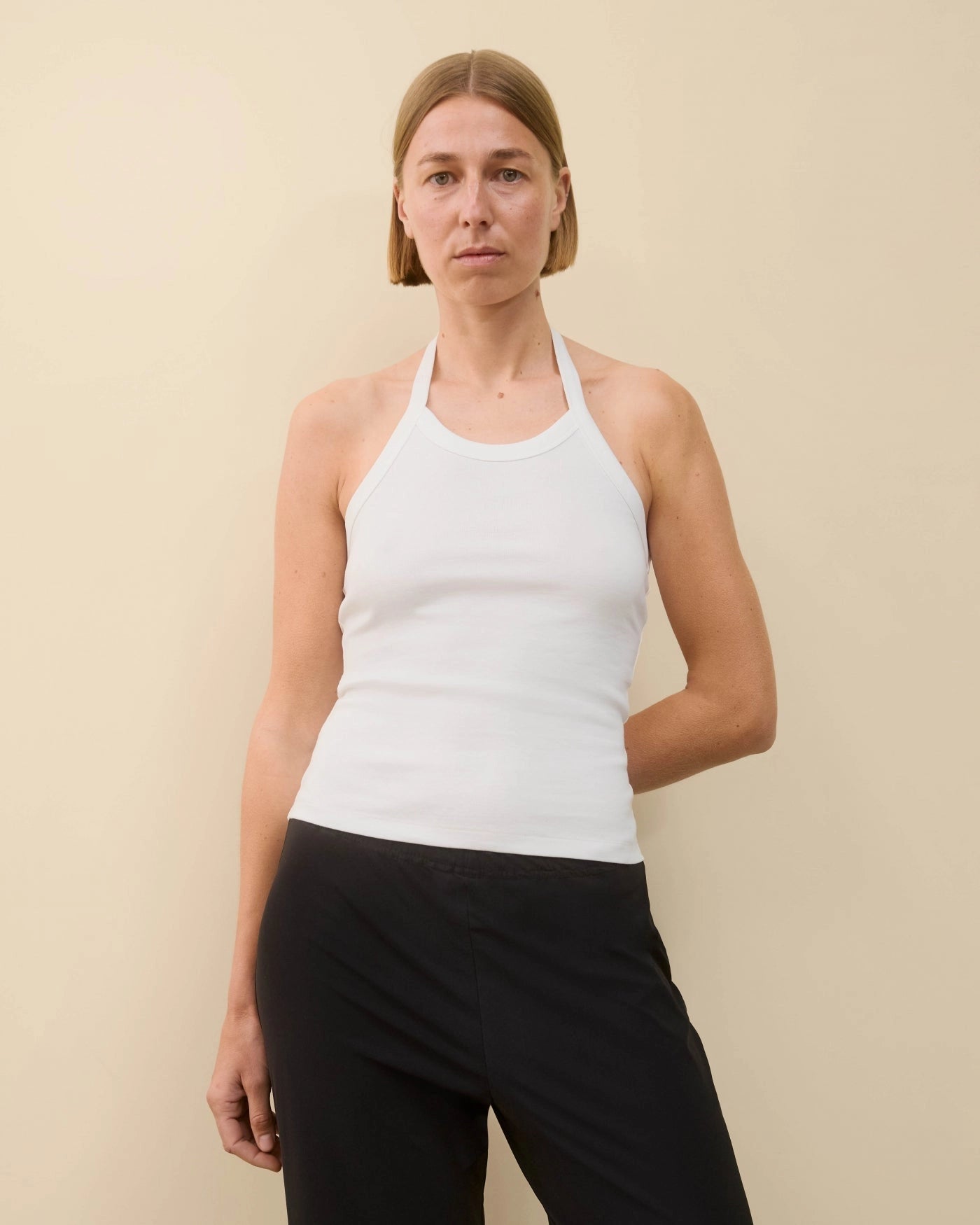 Model wearing Angie Tank in White by FLORE FLORE
