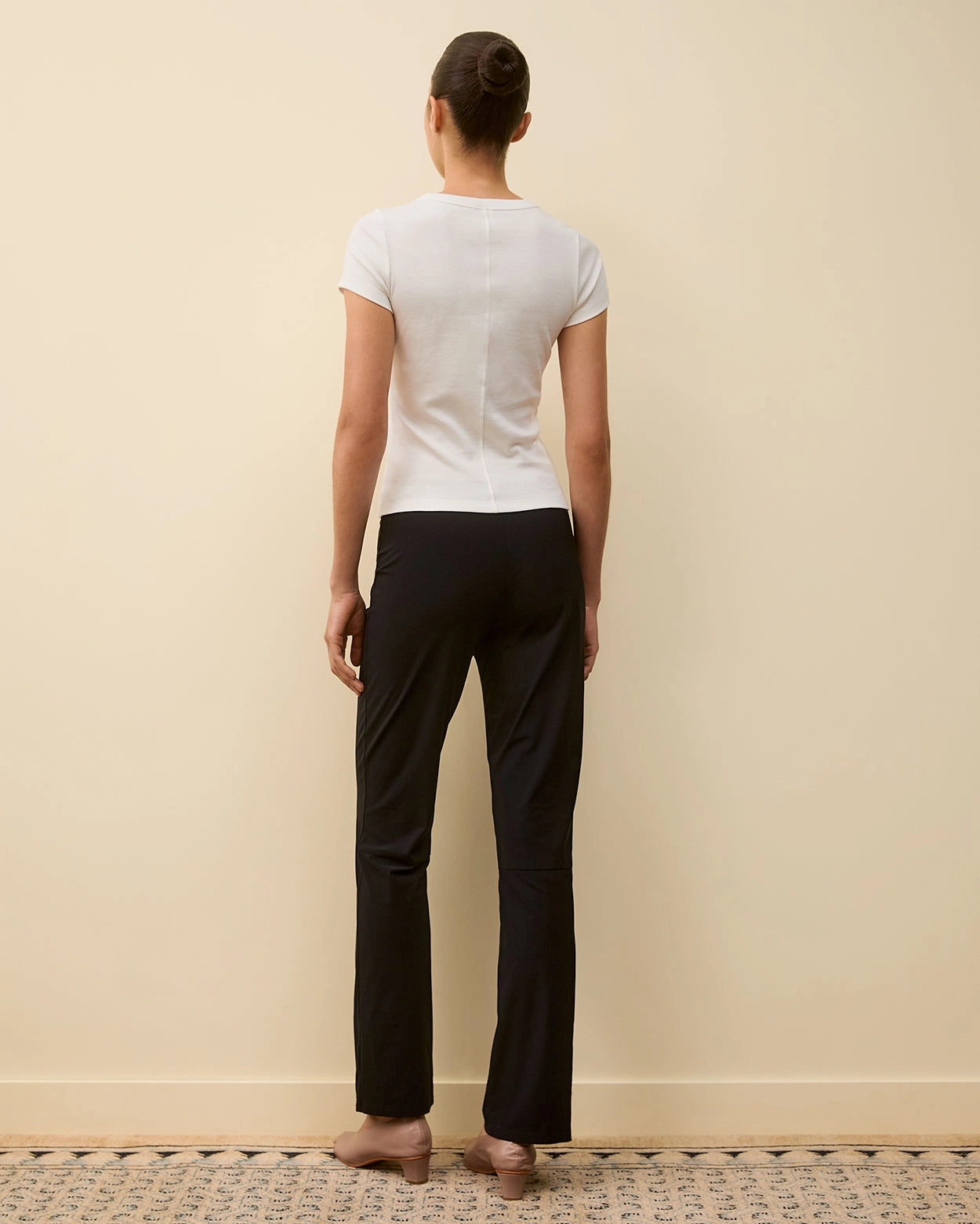 Back view of model wearing Car Baby Tee in White by FLORE FLORE