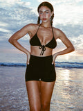 Model wearing Gil Rodriguez Benton Hot Short in black with a super high-rise fit, elastic waistband and short inseam.