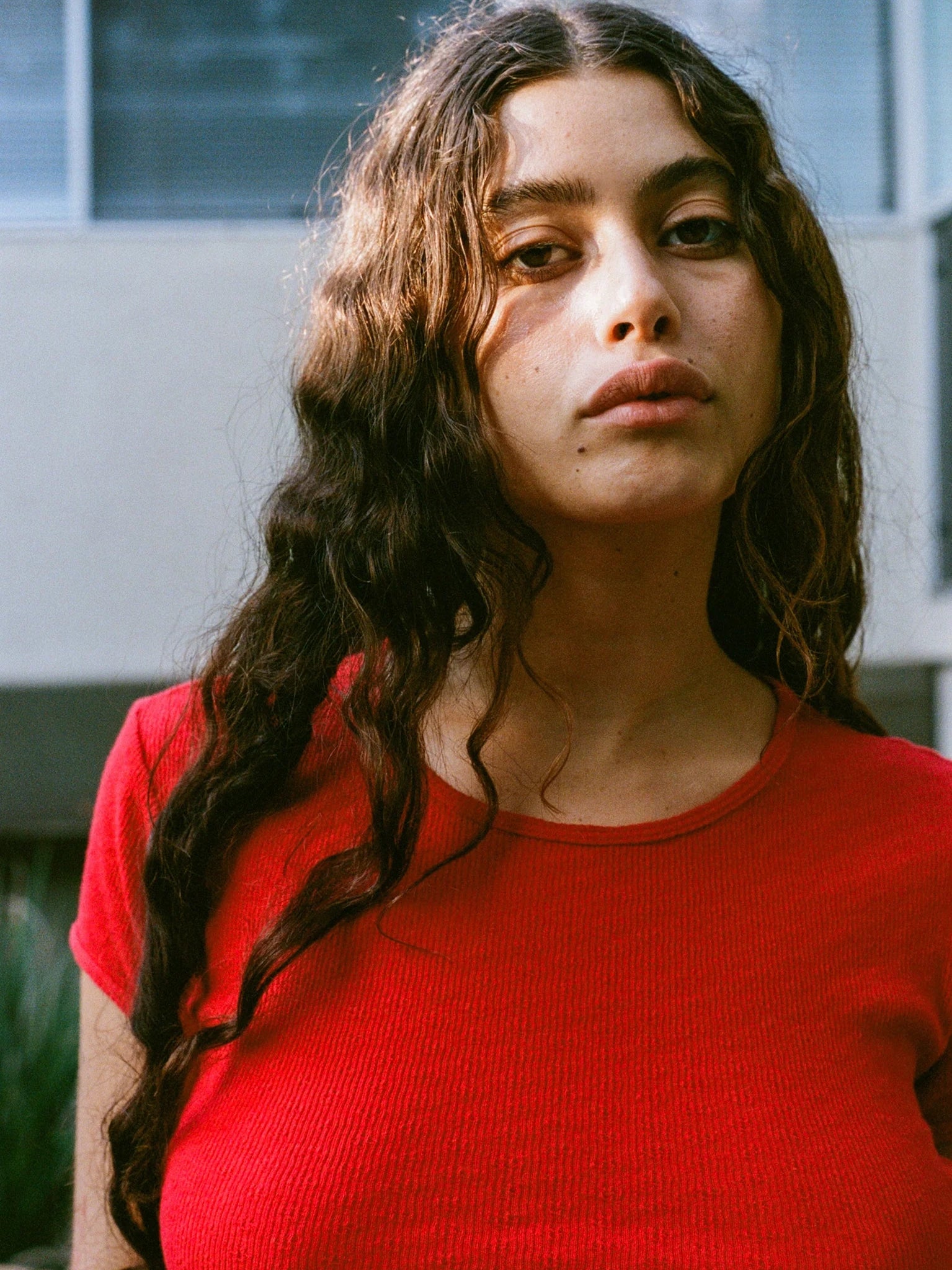 Woman wearing a red shirt with a blurred background