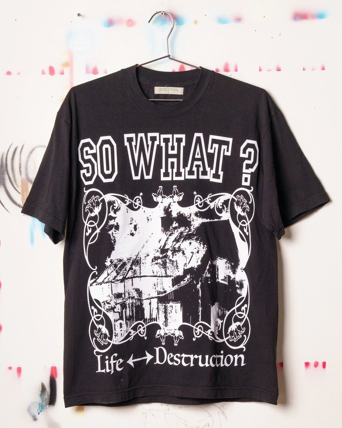 Black Henry Johnson graphic tee with oversized SO WHAT? typography, distressed artwork and Life ↔ Destruction lettering on the front.
