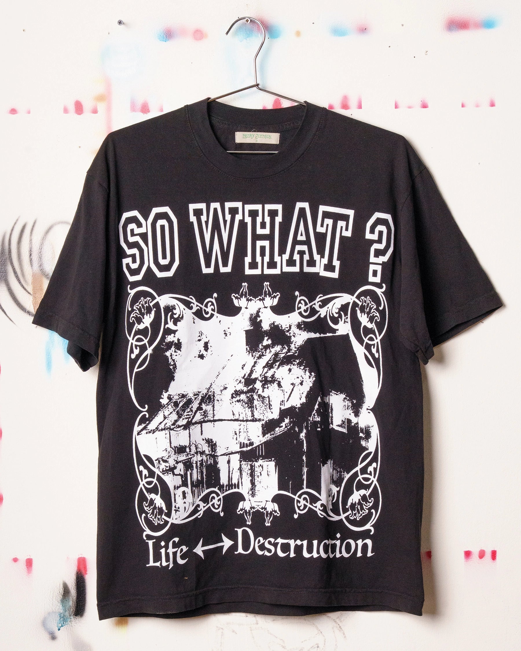 Black Henry Johnson graphic tee with oversized SO WHAT? typography, distressed artwork and Life ↔ Destruction lettering on the front.