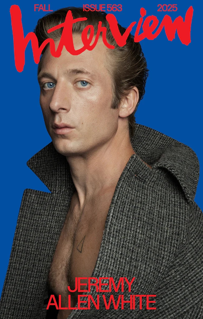 Magazine cover featuring a person with a blue background and 'Interview' branding.