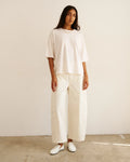 Model wearing The Baggy Painter Crop in Ecru by Jamie Haller with a white oversized T-shirt.