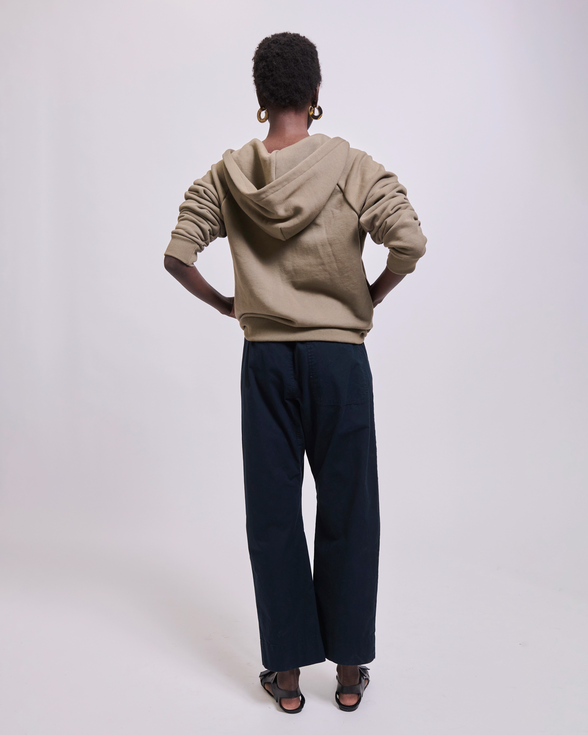 Model wearing The Bird Hoodie in Loden by Jamie Haller.
