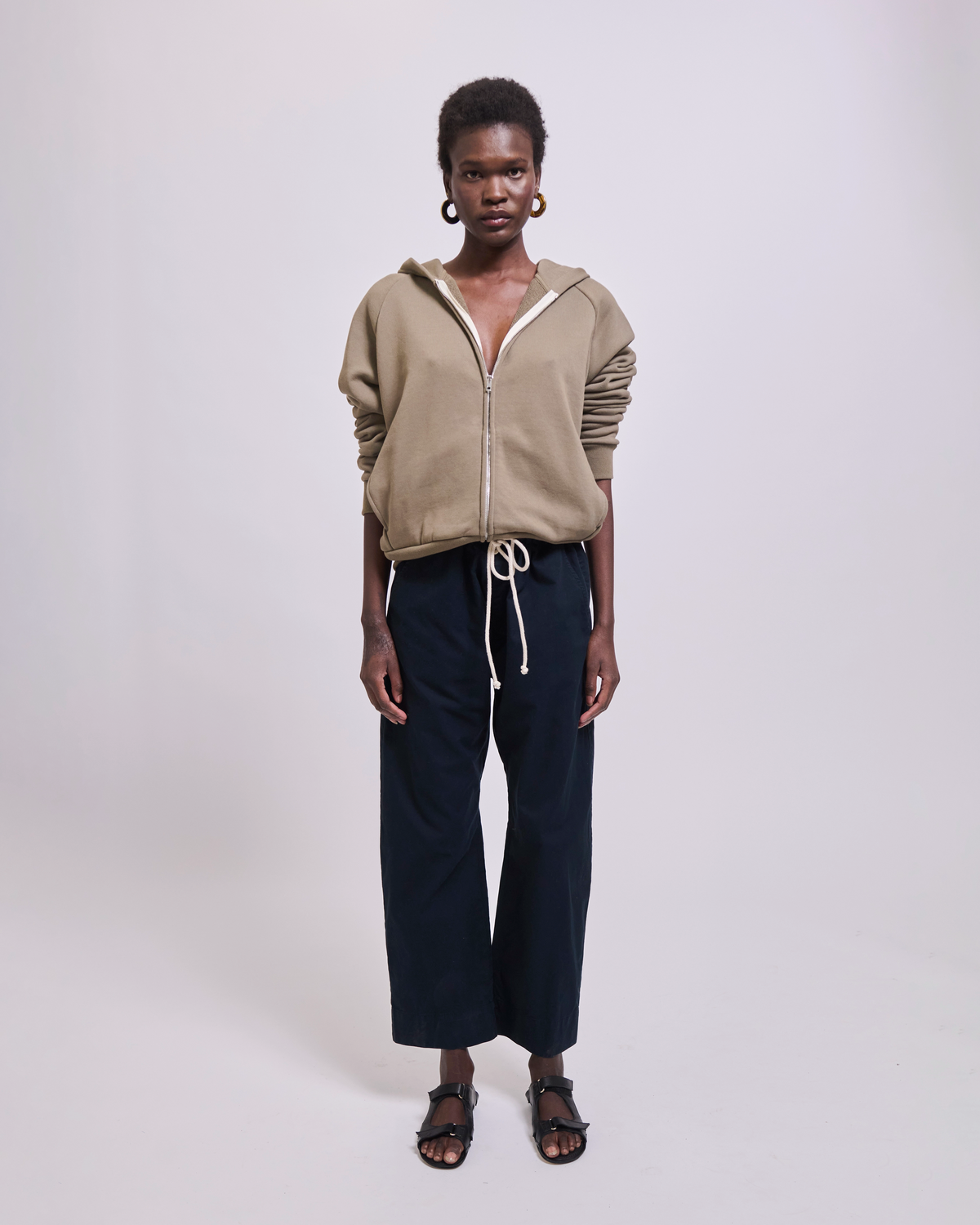Model wearing The Bird Hoodie in Loden by Jamie Haller.