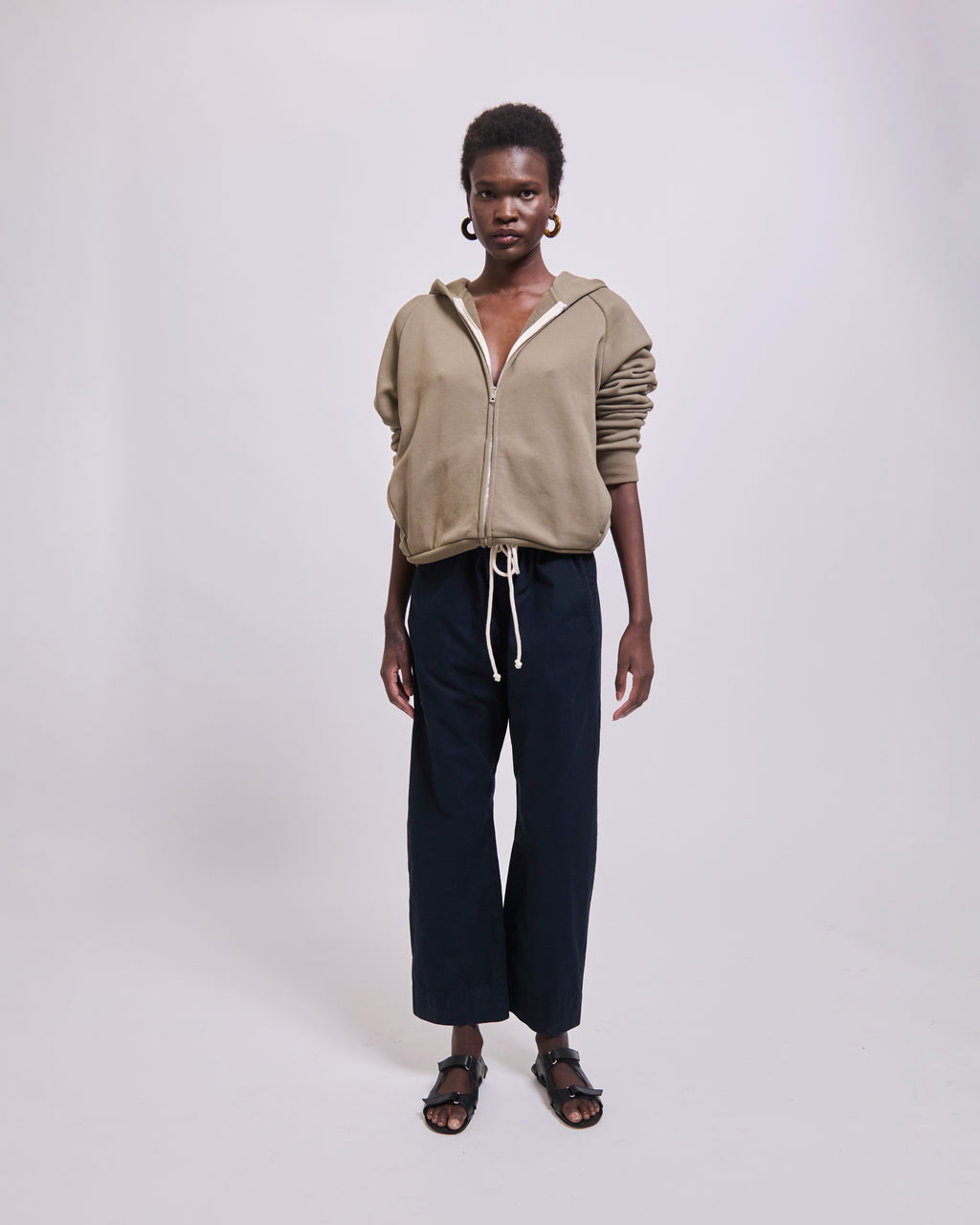 Model wearing The Bird Hoodie in Loden by Jamie Haller.