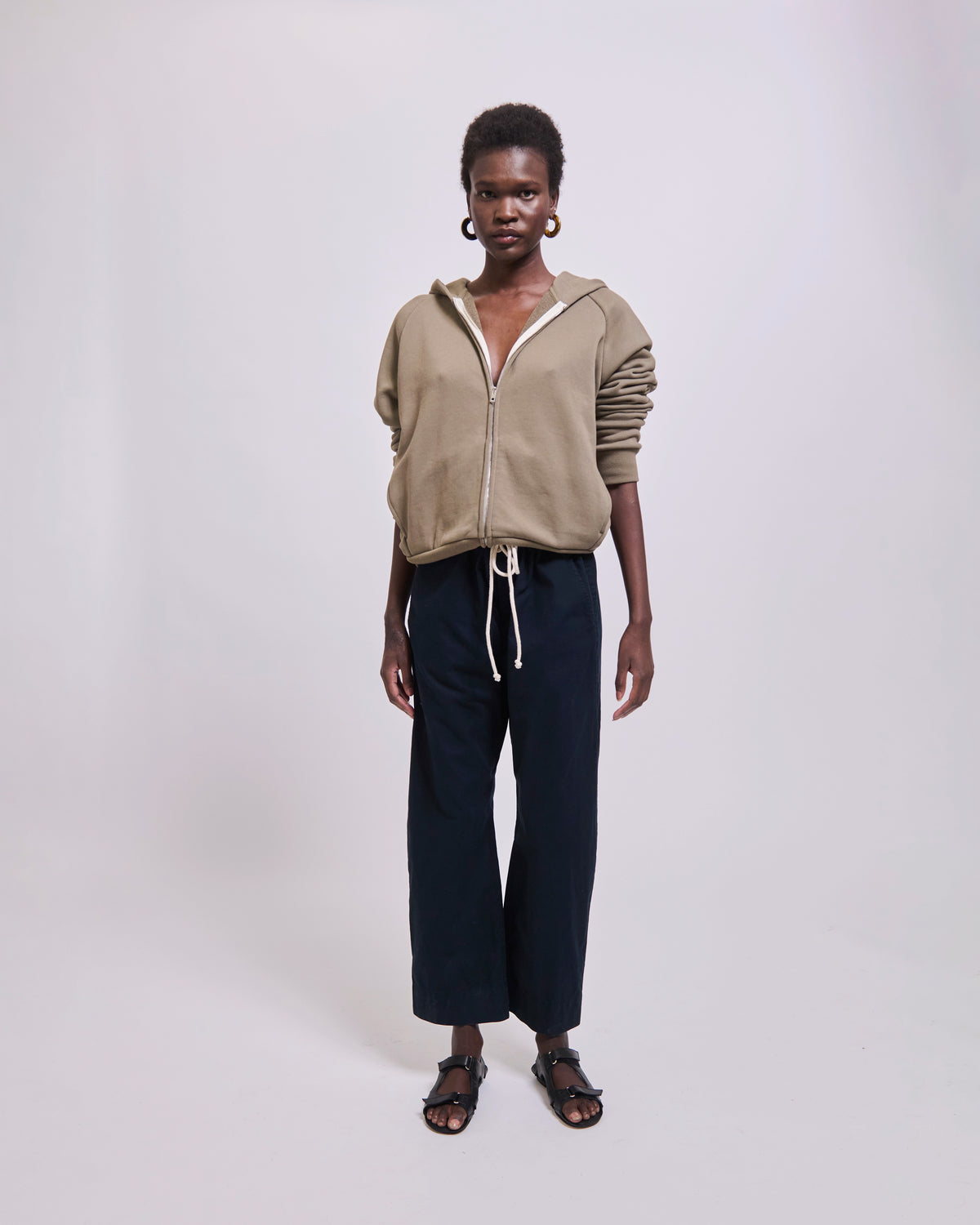 Model wearing The Bird Hoodie in Loden by Jamie Haller.