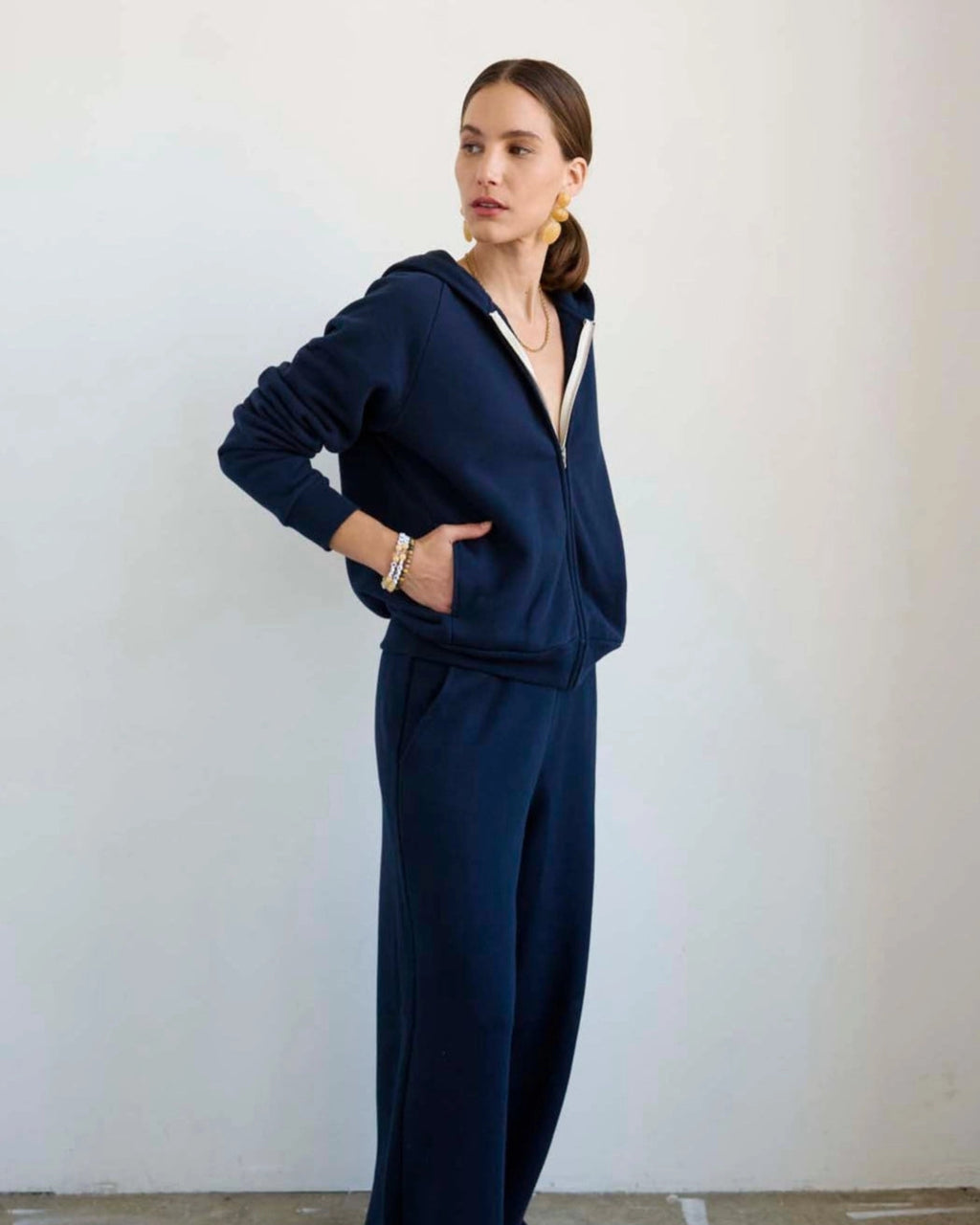 Model wearing Jamie Haller Bird Hoodie in navy.