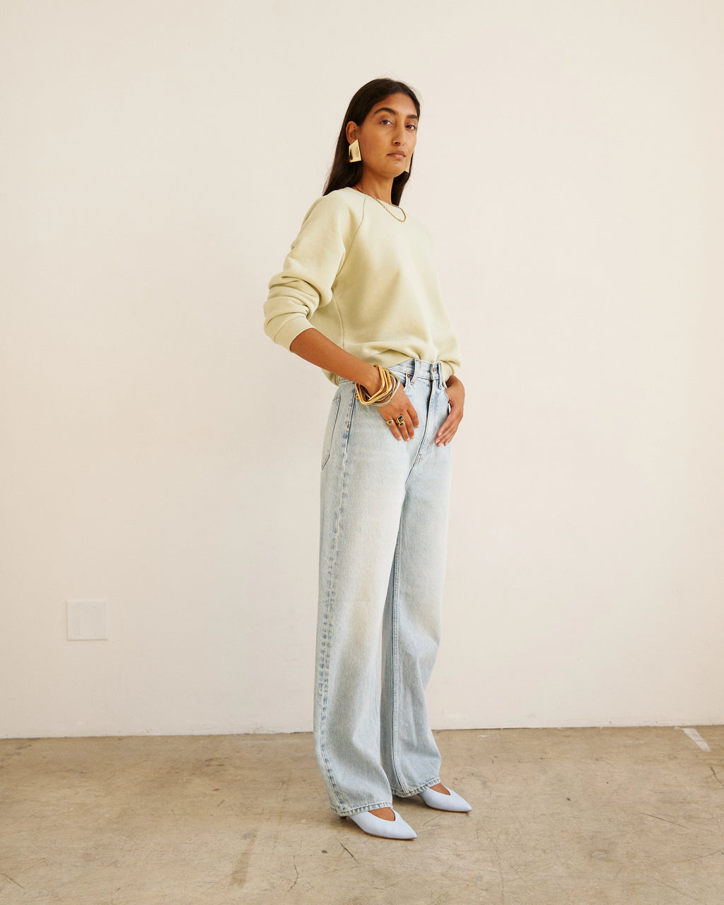 Model wearing Jamie Haller Fan Jean in light stone with a high-rise tapered fit and vintage-inspired wash.