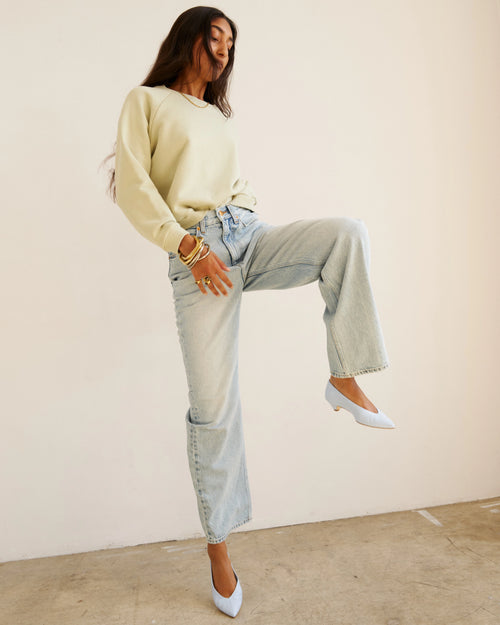 Model wearing Jamie Haller Fan Jean in light stone with a high-rise tapered fit and vintage-inspired wash.