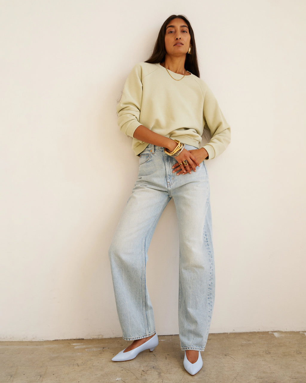 Model wearing Jamie Haller Fan Jean in light stone with a high-rise tapered fit and vintage-inspired wash.