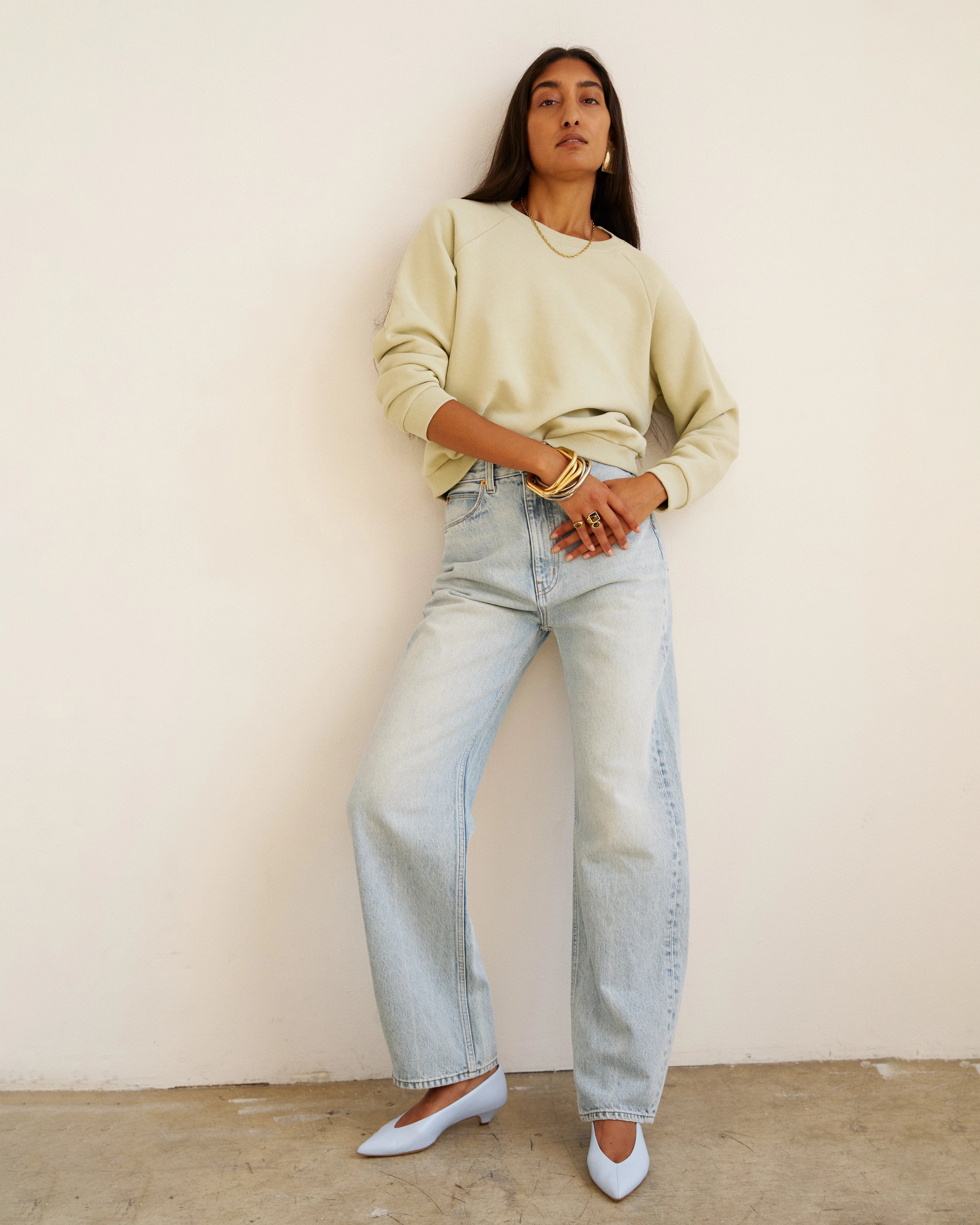 Model wearing Jamie Haller Fan Jean in light stone with a high-rise tapered fit and vintage-inspired wash.