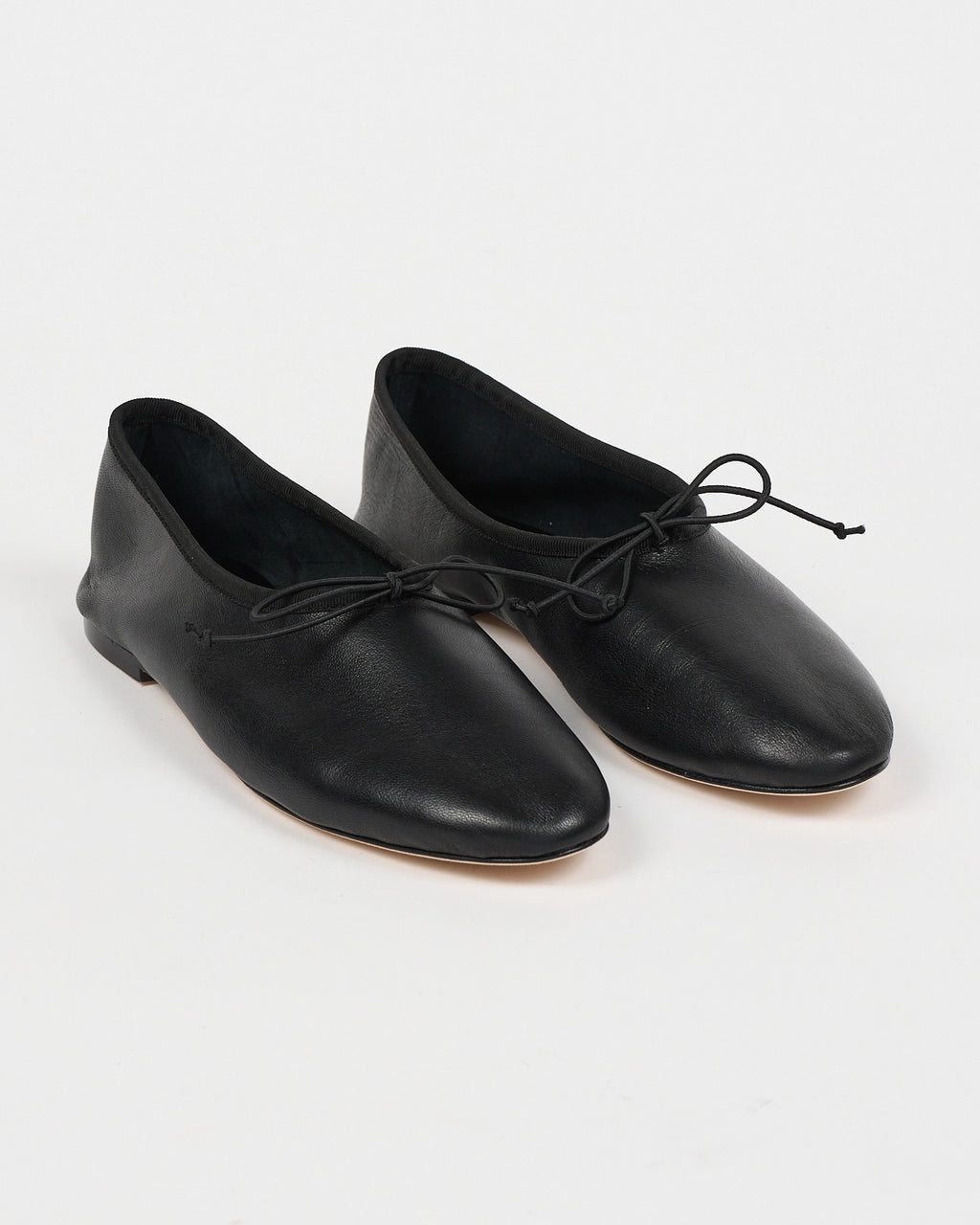 Jamie Haller High Vamp Ballet in black with an elongated shape and elastic bow tie.