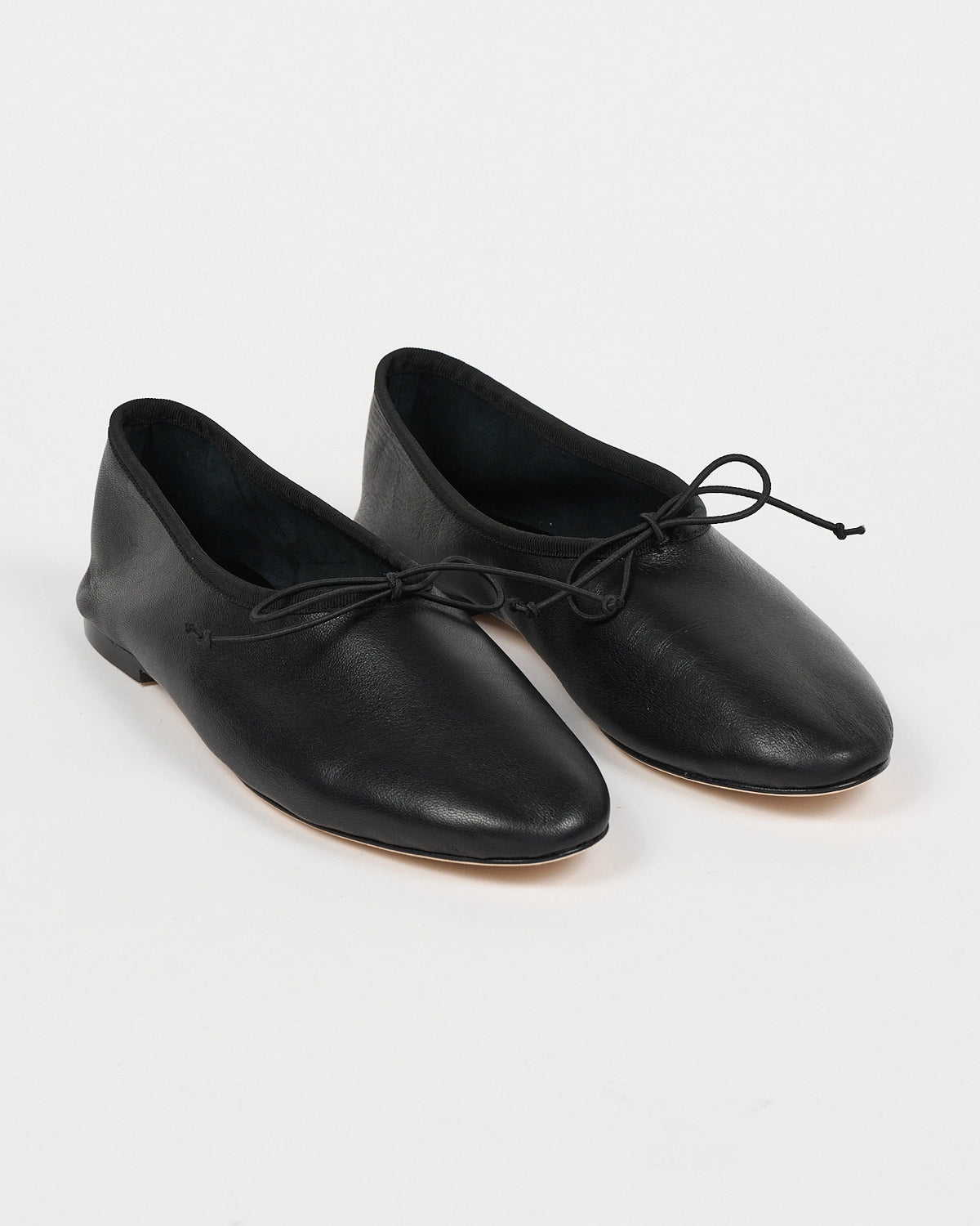 Jamie Haller High Vamp Ballet in black with an elongated shape and elastic bow tie.